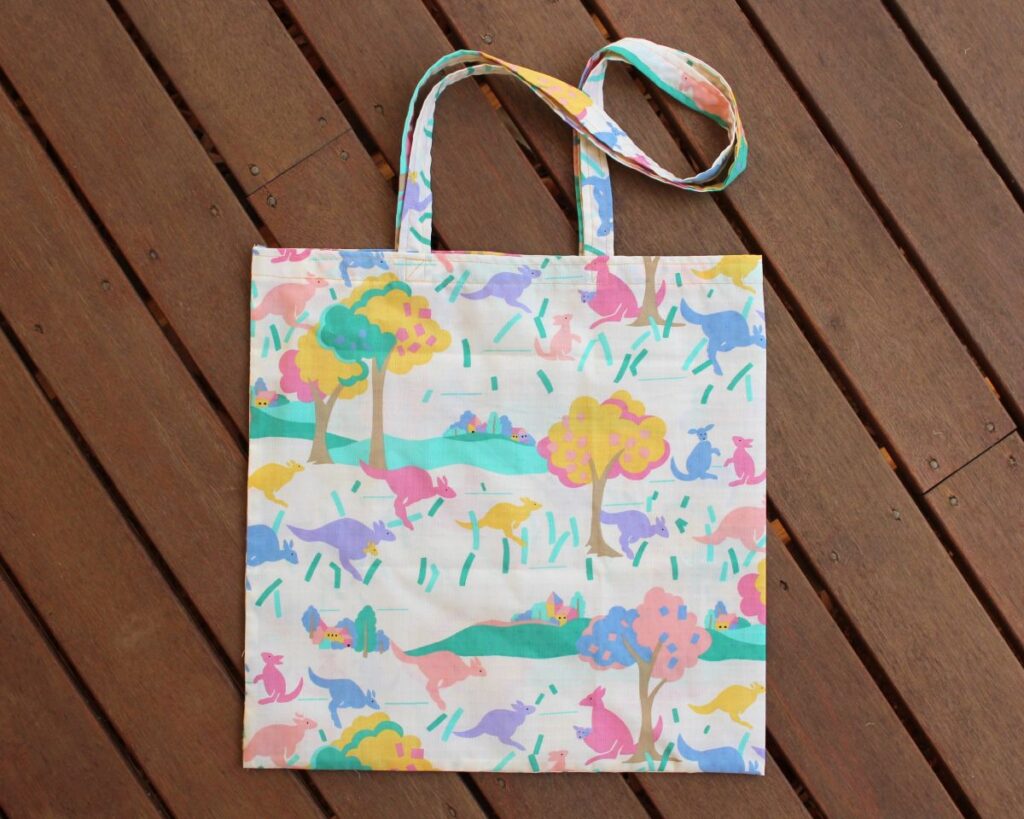 A tote bag shoulder made from vintage fabric, a fun Australian animal print in bright colours.