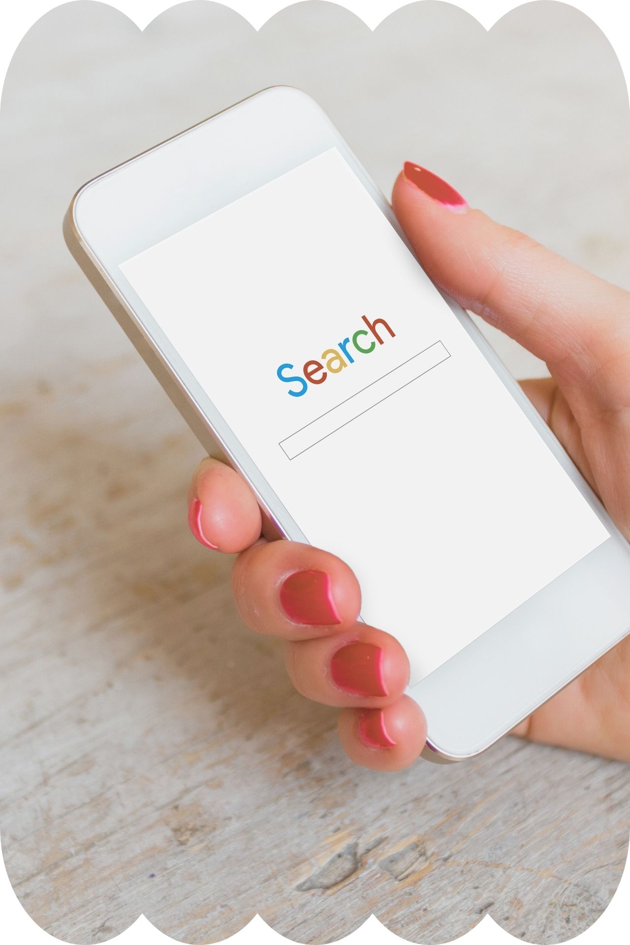 DIY-SEO-hand-holding-phone A white hand holding a mobile phone, which has the word 'search' in Google's colours on the screen