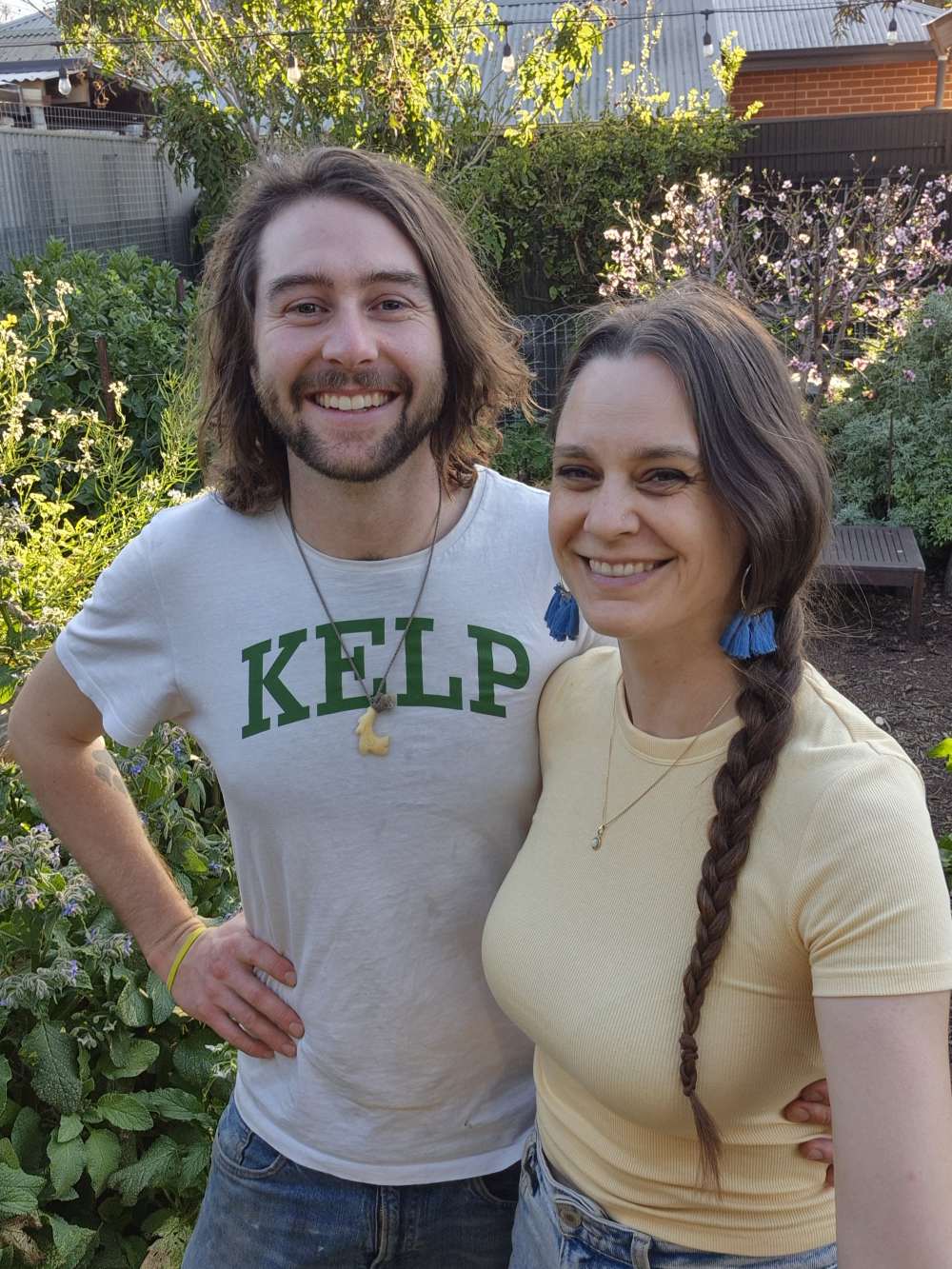 Urban permaculture workshop hosts Kym and Koren, standing in the garden you'll visit.