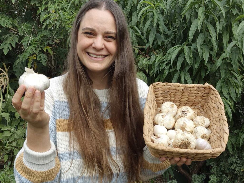 Koren Helbig with a basket of homegrown garlic cloves, ready to plant into the garden